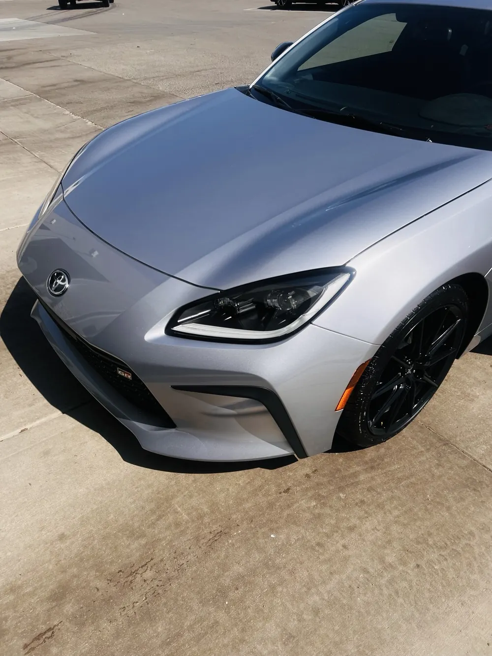 Silver Toyota GR sports car with a glossy hood and clean front end