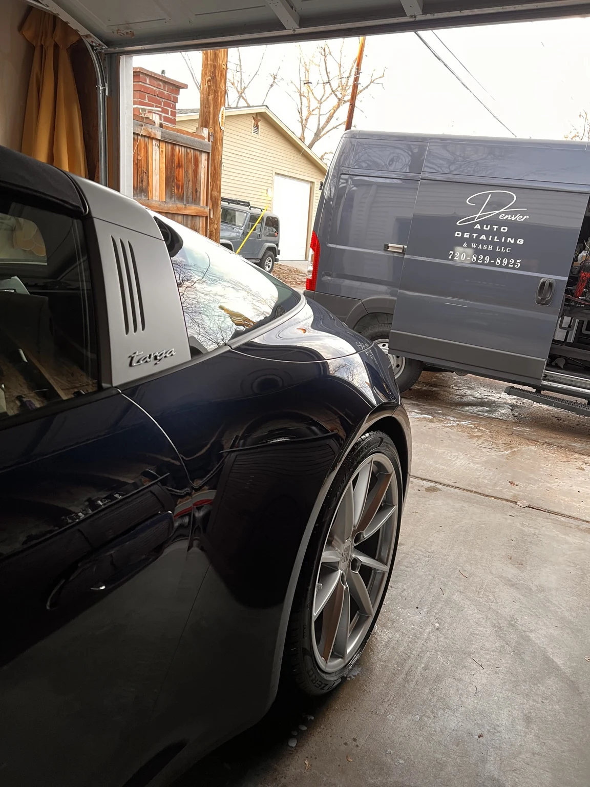 Porsche Targa parked beside the Denver Auto Detailing & Wash van during service